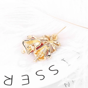Back view of Christmas bells napkin ring with gold metal pin and red enamel finish