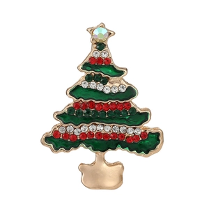 Golden Christmas tree brooch with green enamel and colorful rhinestones on white background