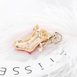 Christmas stocking brooch in gold-plated alloy with festive red and green enamel coating