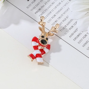 Christmas elk brooch pin in gold finish with red and white striped scarf on a card