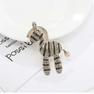 Elegant zebra brooch pin with black and white rhinestones and sparkling green eyes