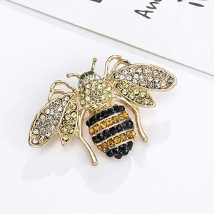 Creative bee brooch pin in gold alloy featuring yellow crystals and sparkling green eyes