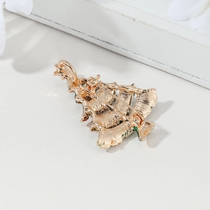 Back view of a Christmas tree brooch in gold metal with a secure pin clasp and enamel detail