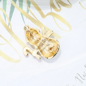 Back view of gold-plated snowman brooch showing secure safety pin clasp details