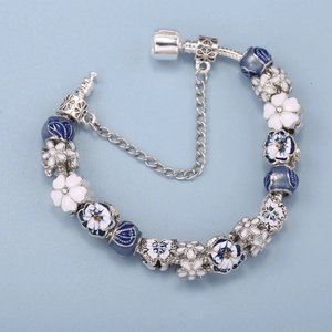 Blue and white floral charm bracelet with daisy enamel beads on silver snake chain
