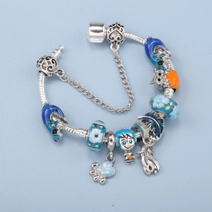 Classic silver snake chain bracelet with blue enamel owl, boy, and glass bead charms