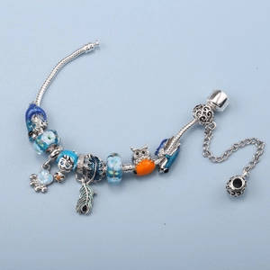 DIY charm bracelet with blue glass beads and owl pendants on silver snake chain