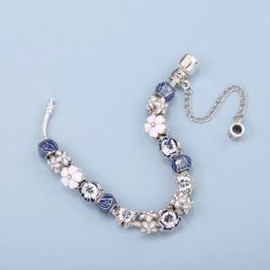 Blue and white floral charm bracelet with silver snake chain and enamel daisy beads