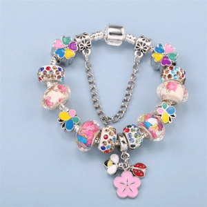 Spring style charm bracelet with floral glass beads, bee and ladybug charms on snake chain