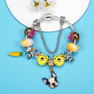 Colorful DIY charm bracelet with unicorn, donut, and puppy pendants on silver snake chain