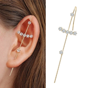 Detailed close-up of golden lightning-shaped climber earrings with inlaid white zircons