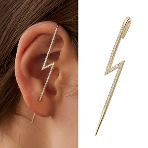 Detail of gold lightning bolt ear crawler with white zircons and pearls on ear