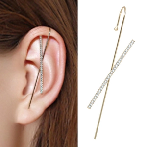 Detail of gold ear cuff with crossover design featuring pavé cubic zirconia accents