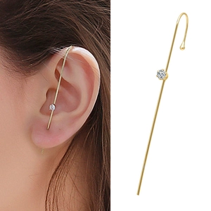 Detail of lightning bolt ear cuff with pearl and zircon inlay worn on a model ear