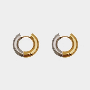 Detail of two-tone hoop earrings with a gold and silver metallic polished finish