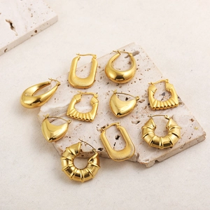 Detailed collection of 18K gold plated stainless steel hoop earrings on stone tray