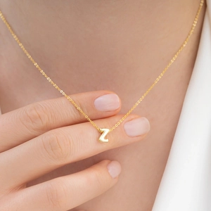 Detail of 18K gold-plated stainless steel bubble letter Z pendant on a delicate chain