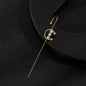 Detailed view of a gold ear crawler with sparkling cubic zirconia stones and pearls