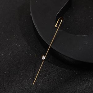 Detail of minimalist 18K gold-plated lightning earring with marquise-cut zircon stones