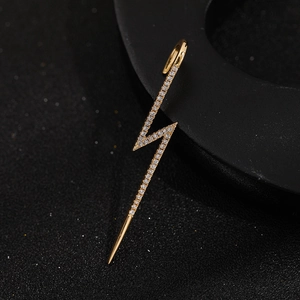 Detailed close-up of a gold-plated lightning bolt ear stud with pavé white zircon stones
