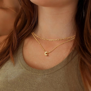 Golden double-layered necklace with 3D bubble letter C pendant on minimalist chain