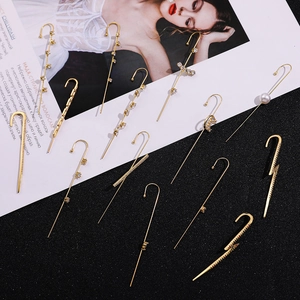 Golden lightning earrings set with pearls and star zircon on a stylish background