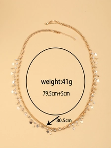 Detailed view of double-layer gold waist chain with butterfly pendants and crystal accents
