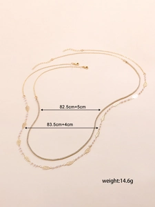 Double-layered gold body chain with hollow leaf charms and sparkling crystal star details