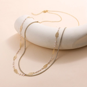 Detail of gold double-layered waist chain with star fringe and white crystal inlay
