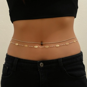Detail of double-layer gold waist chain featuring leaf charms, pearls, and rhinestones