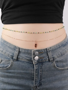 Close-up of double-layered waist chain with gradient beads and thin golden alloy links