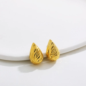 Detailed view of water drop stud earrings with faceted gold finish and 18K plating