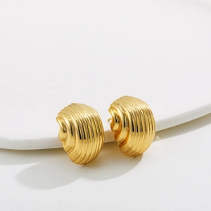 Detailed close-up of 18K gold-plated stainless steel croissant hoop earrings on white stone