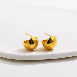 Close-up of 18K gold plated bean stud earrings with hammer textured faceted surface