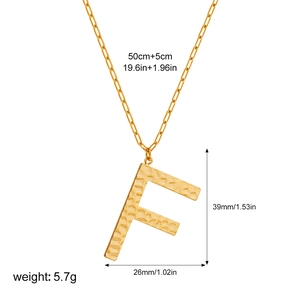 Detail of gold letter F pendant with hammered texture and 55cm long chain necklace