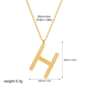 Detailed view of hammered gold letter H pendant with paperclip chain and size specs