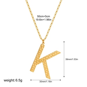 Detail of gold letter K pendant with hammered texture and paperclip chain dimensions