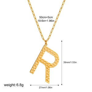 Detail of gold letter R pendant with hammered texture and measurement dimensions