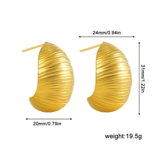 Detail view of 18K gold chunky hoop earrings with shell-like textured metal surface
