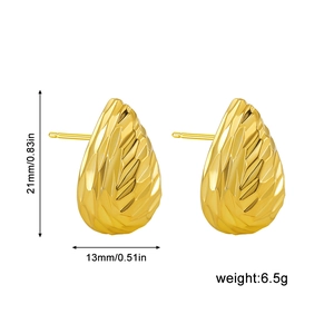 Detailed view of 18K gold geometric stud earrings with faceted texture and dimensions