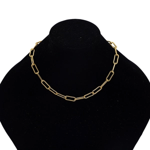 Detail of chunky gold chain necklace with paperclip links on a black bust display