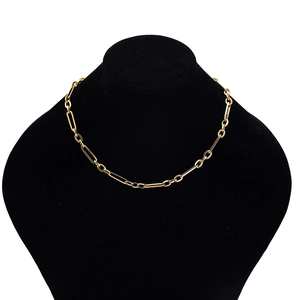 Close-up of gold paperclip chain necklace on a black velvet mannequin stand