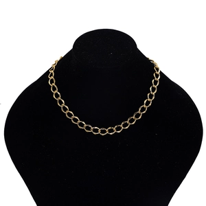 Macro shot of chunky gold alloy chain necklace detail on black velvet bust stand
