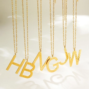 Gold stainless steel initial necklaces with hammered texture pendants on link chains