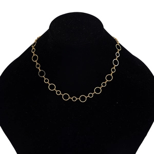 Punk style chunky gold chain necklace with interlocking geometric links on black display