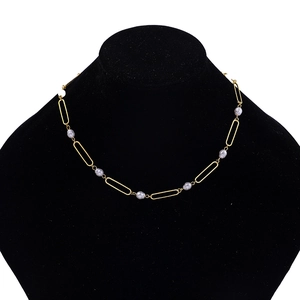 Chic gold alloy chain necklace with oval links and white pearls on jewelry stand