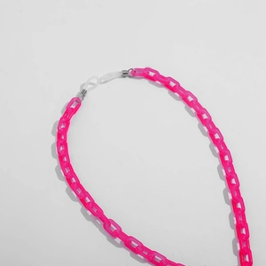 Close-up of translucent rose red acrylic eyewear chain with silicone loops and metal springs