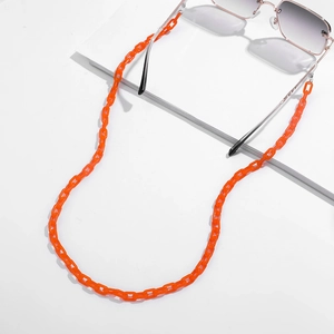 Close-up of bright orange acrylic eyeglass chain with secure clear silicone loops