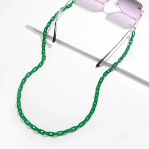 Detail view of vibrant green acrylic glasses chain with gold-toned metal connectors