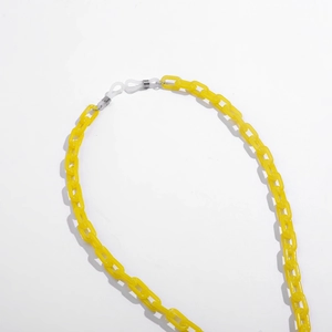 Detail of bright yellow acrylic glasses chain with white silicone anti-slip ends